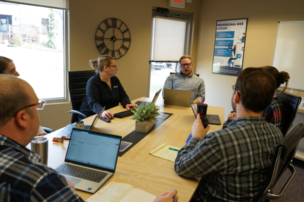 people having a meeting around a table